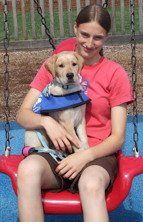 Picture of Toby & I in the park on a swing - Toby's in my lap... and is only 9 weeks!
