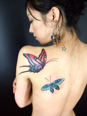 Sexy girl with butterfly tattoo on back body, tribal tattoo on stomach, 