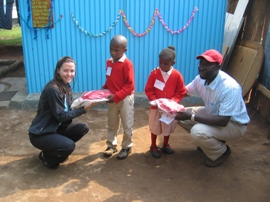 [Mitchell+and+Ken+okoth+presenting+the+kids+at+RedRose+with+new+uniforms+.JPG]