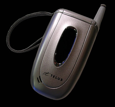 stock photo of silver flip-open style cell phone on black background