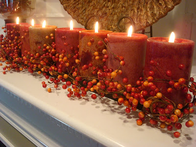 line of warm color candles on fall mantel