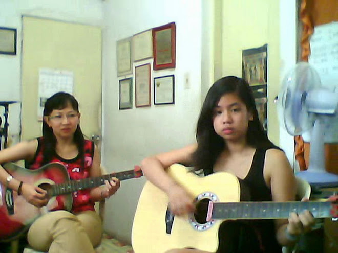 Nicole  at  14  is very serious about her guitar lessons with Mam Jocelyn