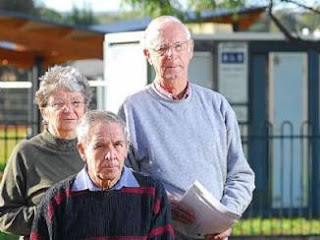 pensioners standing outside a toilet