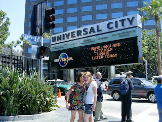 Girls pose in front of sign to Universal Studios