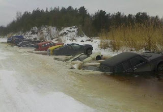 funny crazy photo of cars sinking in frozen lake after thawing