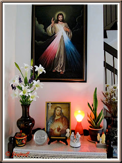 Our altar at home with images of The Divine Mercy and Sacred Heart of Jesus
