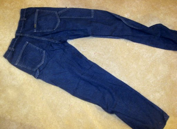 First, I cut the back pockets off of a pair of adult jeans, leaving ...