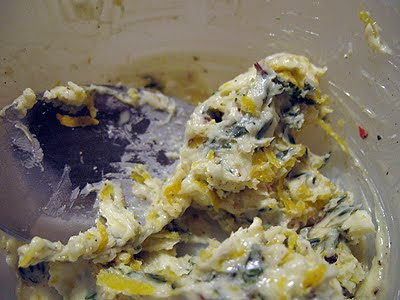 A close up photo of the thyme, lemon zest, pepper and softened butter in a bowl.