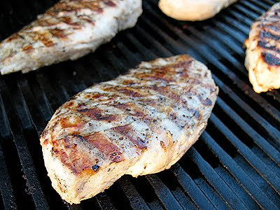 A close up of a chicken breast on the grill.