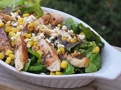 A close up of a grilled chicken salad with herbed tomato vinaigrette. 