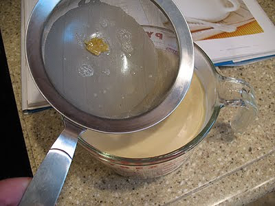 A photo of the ice cream mixture strained into a measuring cup.