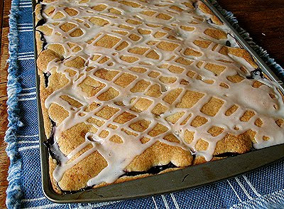 A close up photo of a pan of blackberry pie squares.