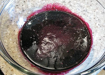 A close up photo of a bowl of mulberry syrup.