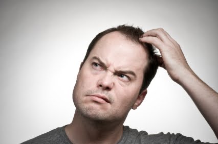 An image of a man scratching his head in confusion
