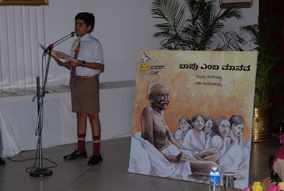 A schoolboy reading excerpts from the book, a man called Bapu