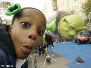 Maurace Morris, 6, of Brooklyn mugs for the camera as the Shrek balloon is inflated in the background.