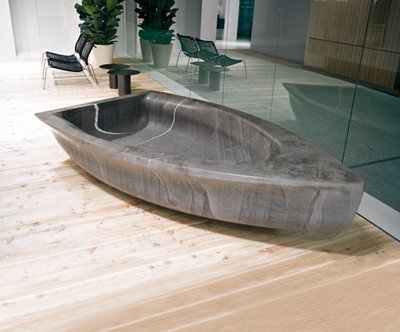 Carlo Columbo's stone carved boat-shaped tub for Antoio Lupi