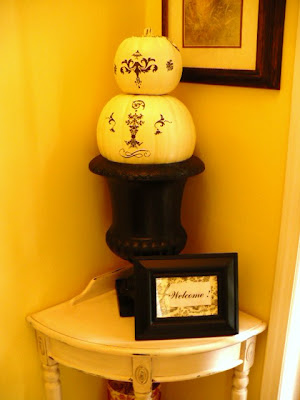 white pumpkins in black urn